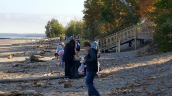 Students collect trash at the beach at Calumet Waterworks Park on Lake Superior.