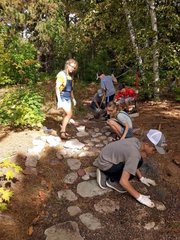 8th grade students working on the rock walkway.