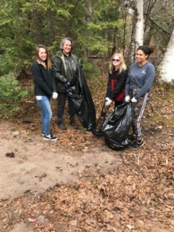 Horizons High School students pick up trash at Gratiot River County Park.